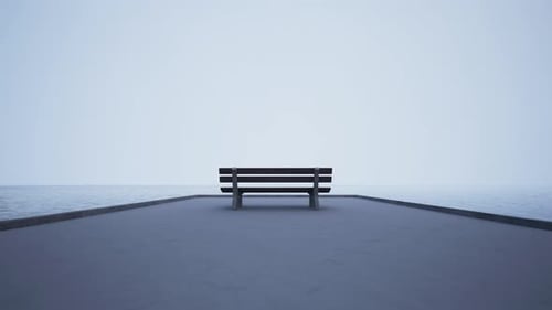 Peaceful Minimalist Bench Overlooking a Calm Misty Ocean