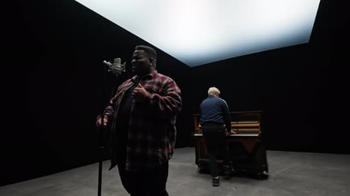A Singer And A Pianist Performs Inside A Studio