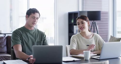Relaxed Man and Woman Work on Laptops at Home