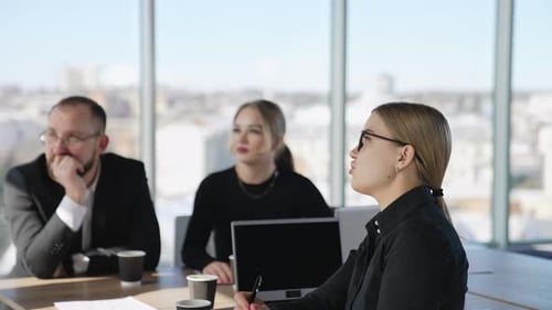 Businesspeople Attending Meeting at Conference Table
