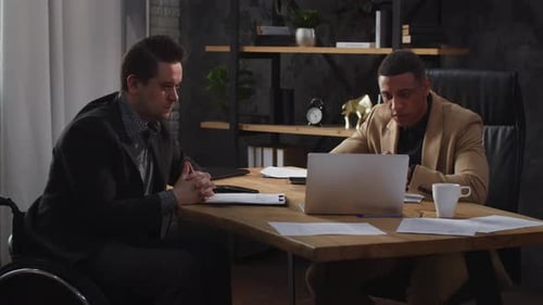 Two Men Collaborating at Modern Office Workplace