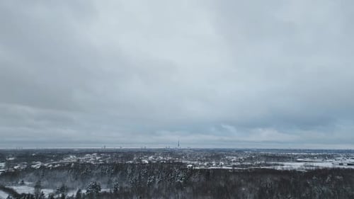 A Breathtaking Aerial View of a Winter Landscape Featuring Snow Covered Forests Beneath Expansive
