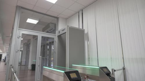 Turnstile Stands at Entrance of Hall with Tiled Floor