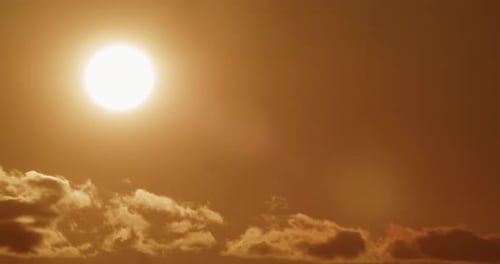 Bright Golden Sun Shining Against Cloudy Sky