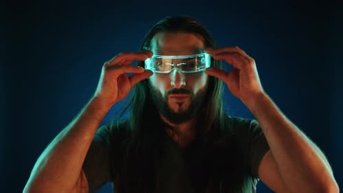 Man Puts on Illuminated Futuristic Augmented Reality Glasses