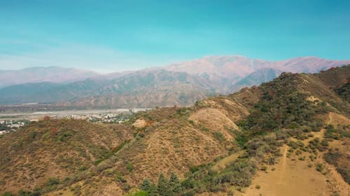 Aerial drone flying over a blue water lake with mountains landscape