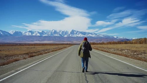 An Adventurous Hikers Remarkable Journey on a Scenic Road Surrounded By Breathtaking Majestic