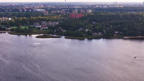 Aerial view of Ķīšezers iake in Riga, Latvia, with primary inflow of the Jugla River, drone fly at s
