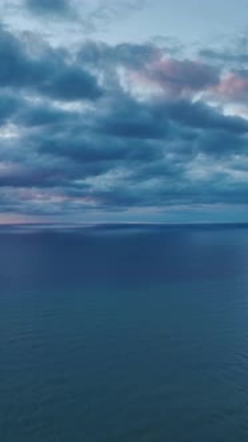 Vertical Video Vibrant Sunset Over the Ocean With Stunning Colors Reflecting on the Water Surface