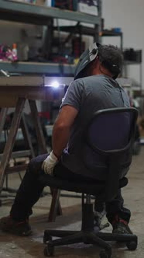 Professional Welder Joining Metal Pieces in Workshop