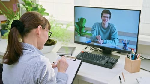 Woman Conducts Virtual Meeting With Young Man