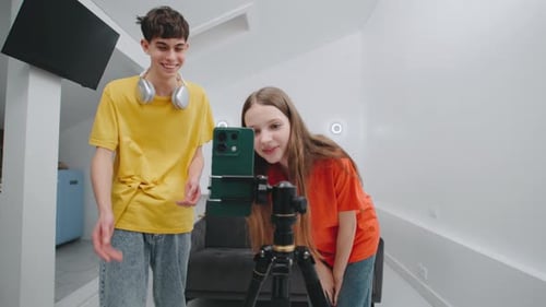 Teens Creating Online Content Using Smartphone on Tripod