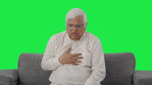 Sick Indian old man suffering from cold and cough Green screen