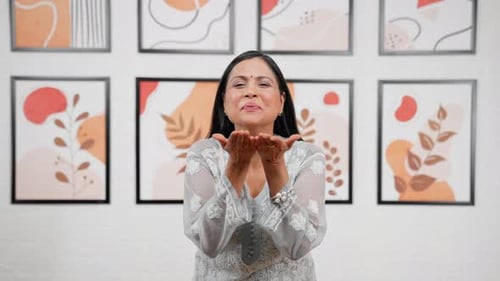 Woman Blowing a Kiss in Front of Art