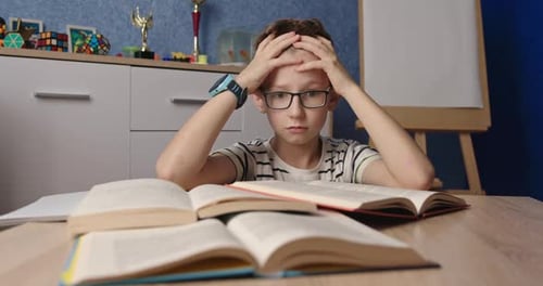 Stressed Boy Studying Hard with Books