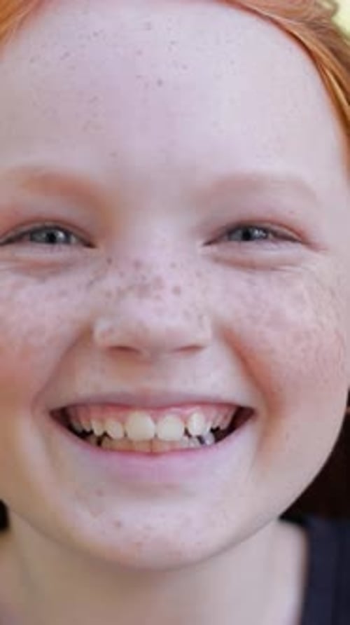 Smiling Red Haired Child in Close Up Portrait