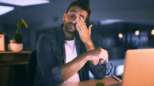 Man, tired and laptop for night office work for company deadline for proposal