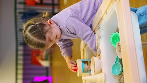 Little Girl Playing with Kinetic Sand and Wooden Toys Sensory Development and Experiences Themed