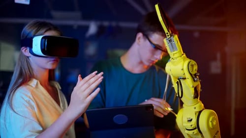 Woman Using VR with Robotic Arm and Tablet