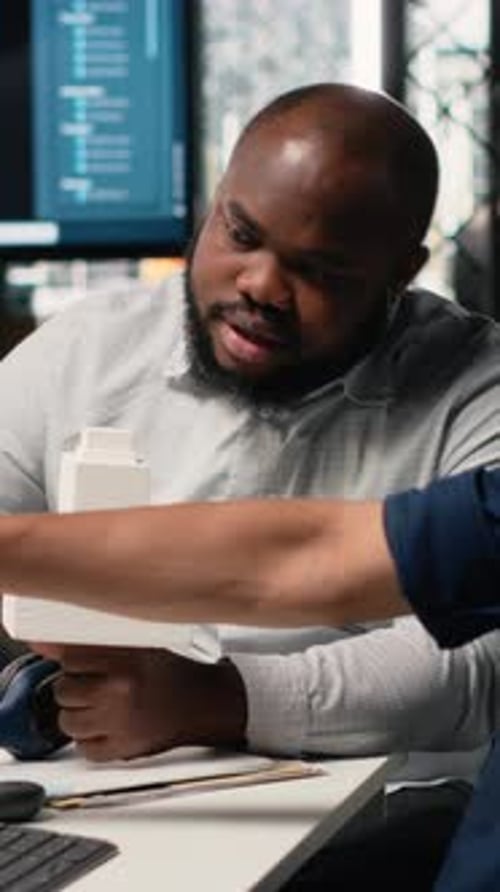 Adult Man Discussing Building Model in Office
