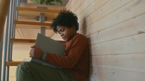 Boy Sitting on Stairs Reading History Book