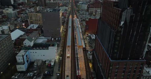 Aerial view tilting over the 125th Street railway station, gloomy evening in Harlem, NY, USA