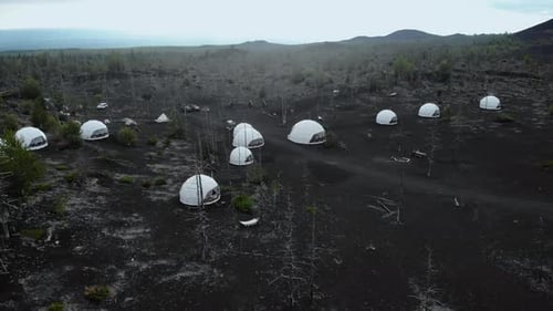Geodesic Dome Tents in Volcanic Landscape Aerial View Media