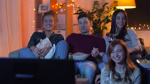 Friends Watching TV Together, Eating Snacks at Home