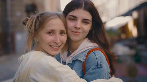 Two Young Women Hugging in the City
