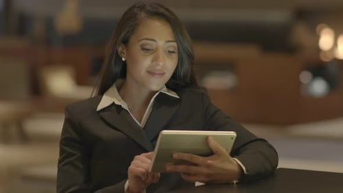 Professional Woman Using Tablet Device in Office Setting
