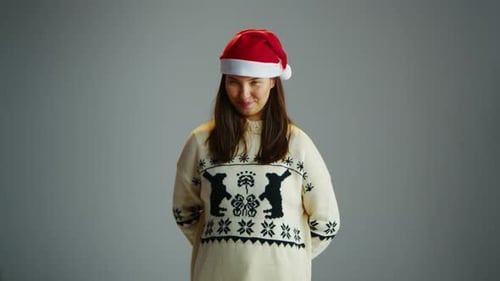 Woman in Santa Hat Offers Christmas Gift