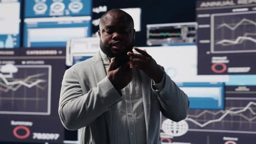 Business Professional Communicating in front of Data Displays