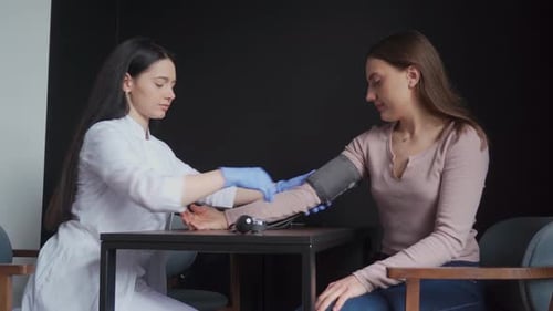 Doctor Examines Patient with Stethoscope and Cuff