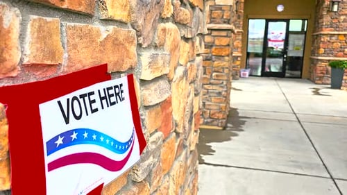 Vote Here Sign in Crisp Close-Up for Political and Election Media