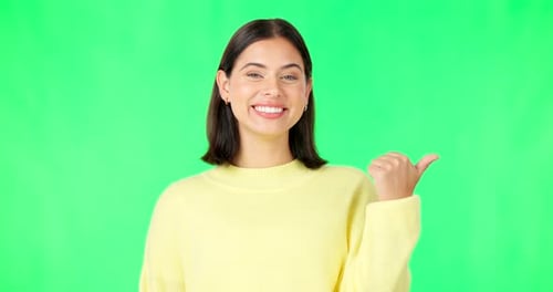 Portrait, pointing and green screen with an advertising woman in studio for marketing