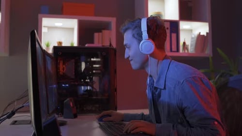 Male Gamer Playing Video Game at Night