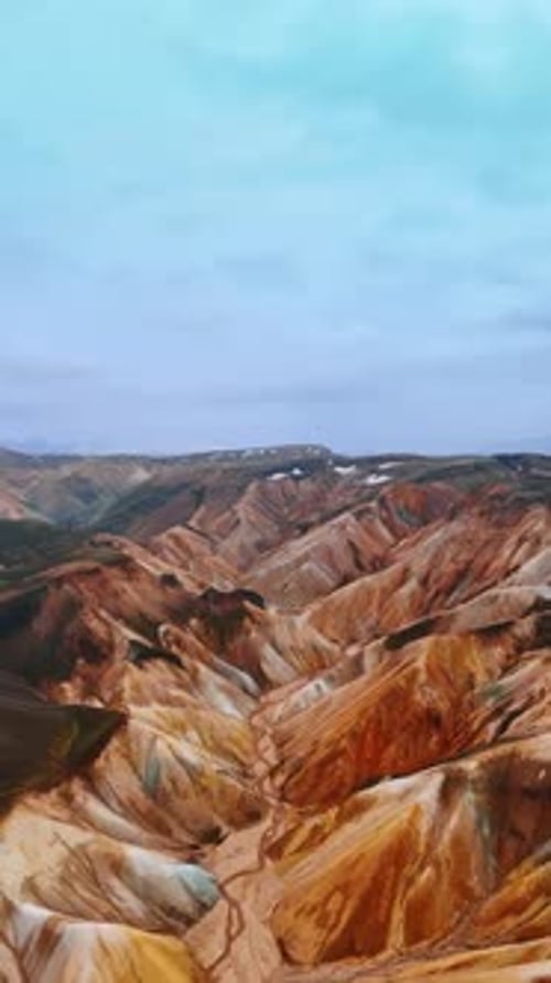 Unreal rocky landscape of terracotta palette. Mountainous territory of Iceland from drone footage.