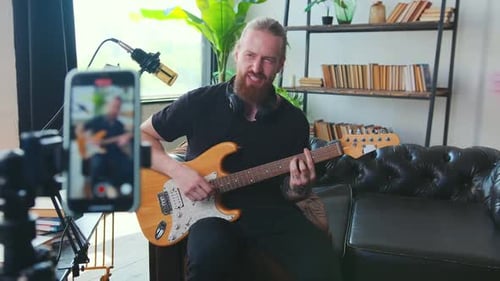 Guitarist Plays Electric Guitar, Recording Video at Home