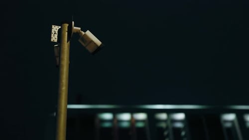 Stealthy Sentinel Dark CCTV Camera Stationed at Corporate Building Provides Constant Vigilance at