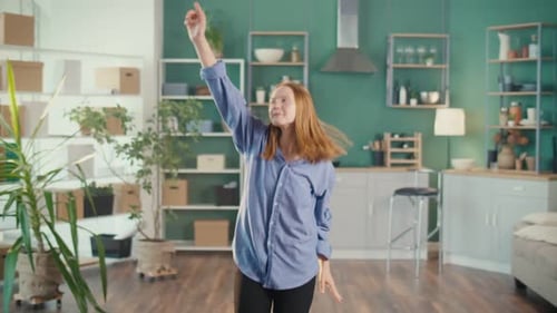 Young Woman Dancing with Joyful Abandon at Home