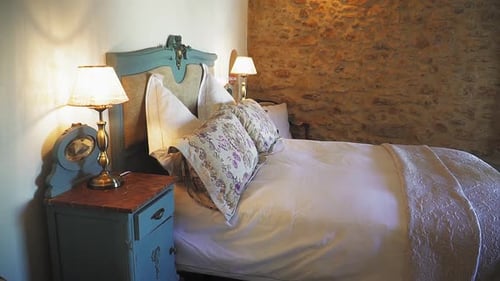 Charming Bedroom Interior with Stone Wall and Bed