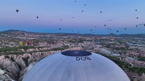 Hot Air Balloons Fly Over the Mountainous Landscape of Cappadocia Turkey