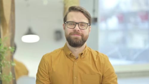 Man With Beard Waving at the Camera