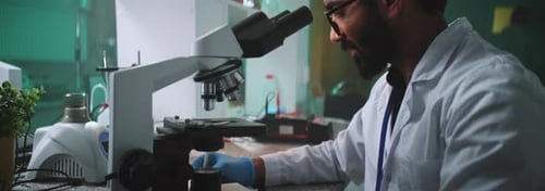 Scientist Using Microscope in Modern Research Laboratory