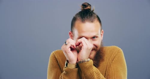Bearded Man Smiling and Making Heart Shape