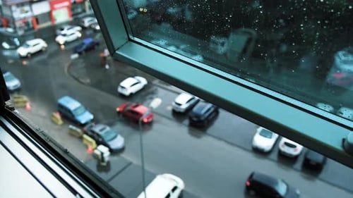 Rainy City Street View from an Open Window