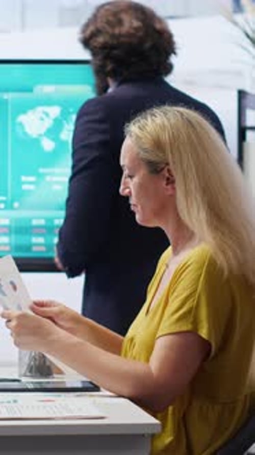 Vertical Video Mom and Gen Z Girl Checking Investment Plan on Display Made By Agent