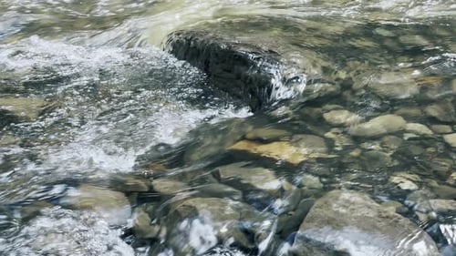 Mountain Creek on Stone Landscape. Closeup Clear Water Stream with Foam On