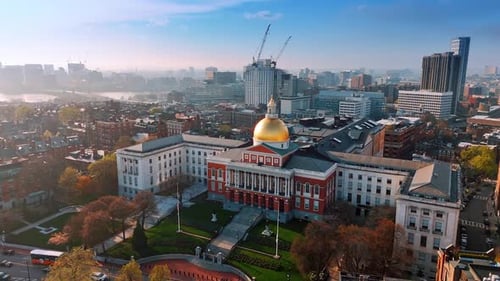 View of Massachusetts State House in Boston. Drone rising over the city covering with smoke.