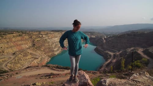 Young Woman Enjoying the View of a Turquoise Lake